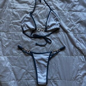 Thong Bathing Suit. White with blue lining. Gold and pearl accents.